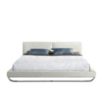 Bed upholstered in leatherette with polished steel legs