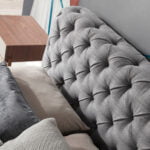 Bed upholstered in tufted fabric