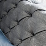 Bed upholstered in tufted fabric