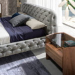 Bed upholstered in tufted fabric