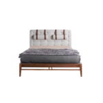 Bed upholstered in fabric with headrest