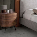 Oval bedside table in walnut wood and black steel legs