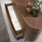 Oval chest of drawers in walnut coloured wood and black steel legs