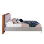 Bed upholstered in fabric and eco-leather with stainless steel legs