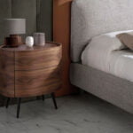 Bed upholstered in fabric and eco-leather with stainless steel legs