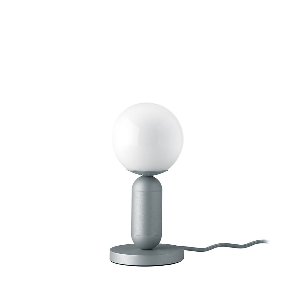 Table lamp with stainless steel base painted in gray epoxy and white tinted glass bulb