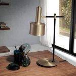 Table lamp in gold-plated aluminium and black steel