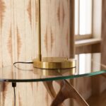 White glass and polished gold-coloured steel table lamp