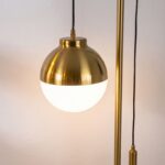 White glass and polished gold-coloured steel floor lamp