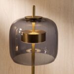 Black smoked glass and polished gold-coloured steel table lamp