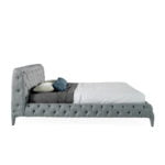 Bed upholstered in tufted fabric