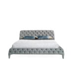 Bed upholstered in tufted fabric