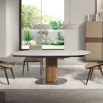 Oval extending dining table with porcelain marble and walnut barrel