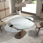 Oval extending dining table with porcelain marble and walnut barrel