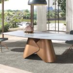 Oval dining table with porcelain marble barrel and bronze-coloured steel barrel