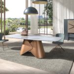 Oval dining table with porcelain marble barrel and bronze-coloured steel barrel