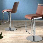 Stool upholstered in leatherette with chromed steel frame