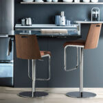 Stool upholstered in leatherette with chromed steel frame
