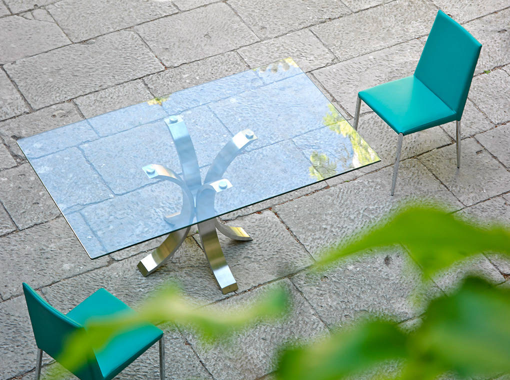 Dining table with polished stainless steel base. Dining table with polished stainless steel base.