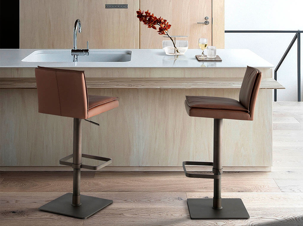 Stool Upholstered in brown leatherette with legs in brown epoxy Stool Upholstered in brown leatherette with legs in brown epoxy