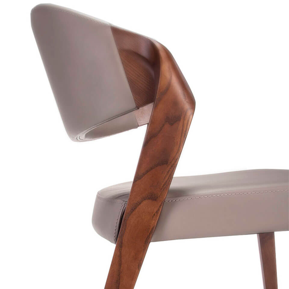 Chair upholstered in leatherette with Walnut colored wooden structure Chair upholstered in leatherette with Walnut colored wooden structure