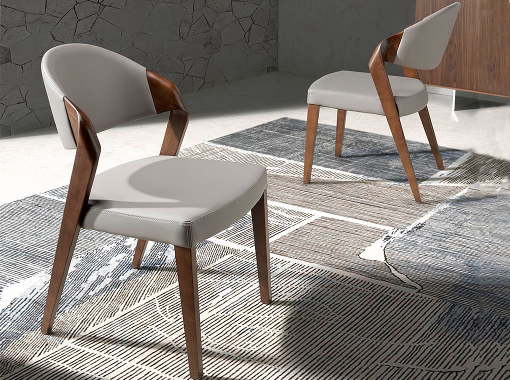 Chair upholstered in leatherette with Walnut colored wooden structure Chair upholstered in leatherette with Walnut colored wooden structure