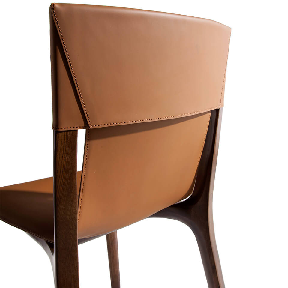 Chair upholstered in leatherette with Walnut colored wooden structure