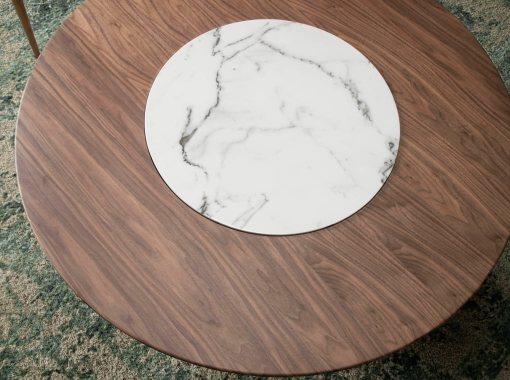 Round dining table in Walnut wood and porcelain detail Round dining table in Walnut wood and porcelain detail