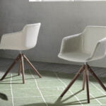 Swivel chair upholstered in fabric with solid wood legs in Walnut color