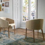 Chair upholstered in fabric with Walnut colored wooden legs