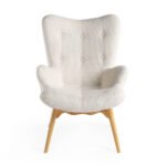 Armchair upholstered in tufted fabric