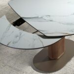 Oval extending dining table with porcelain marble and walnut barrel