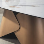 Oval dining table with porcelain marble barrel and bronze-coloured steel barrel