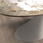 Oval dining table in porcelain marble and sand-coloured epoxy fiberglass