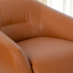 Brown leather swivel armchair