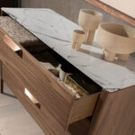Walnut chest of drawers with marble-effect glass top