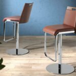 Stool upholstered in leatherette with chromed steel frame