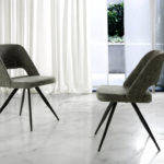 Chair upholstered in fabric with black steel legs