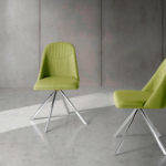 Swivel chair upholstered in fabric with chromed steel legs