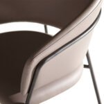 Chair upholstered in leatherette with black steel frame