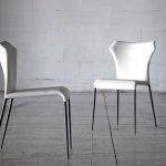 Chair upholstered in leatherette with black steel legs