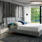 Bed upholstered in fabric with Walnut wood frame