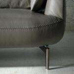 2-seater sofa upholstered in leather with polished steel legs