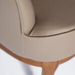 Armchair upholstered in leatherette and Walnut wood legs