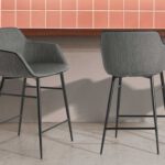 Stool upholstered in fabric with edging and structure in black steel