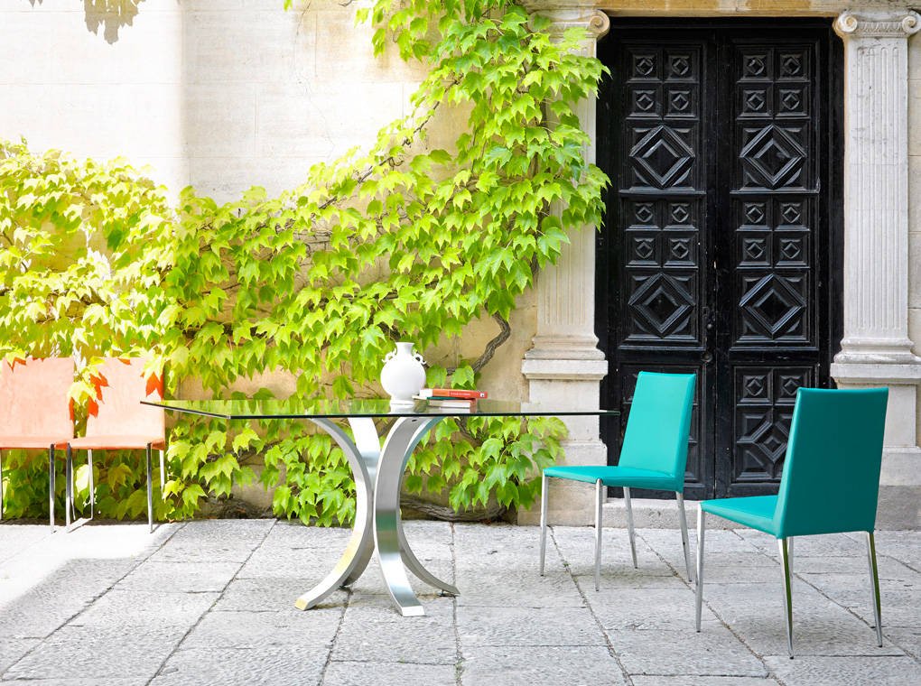 Dining table with polished stainless steel base. Dining table with polished stainless steel base.