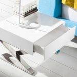White wooden bedside table and chrome steel