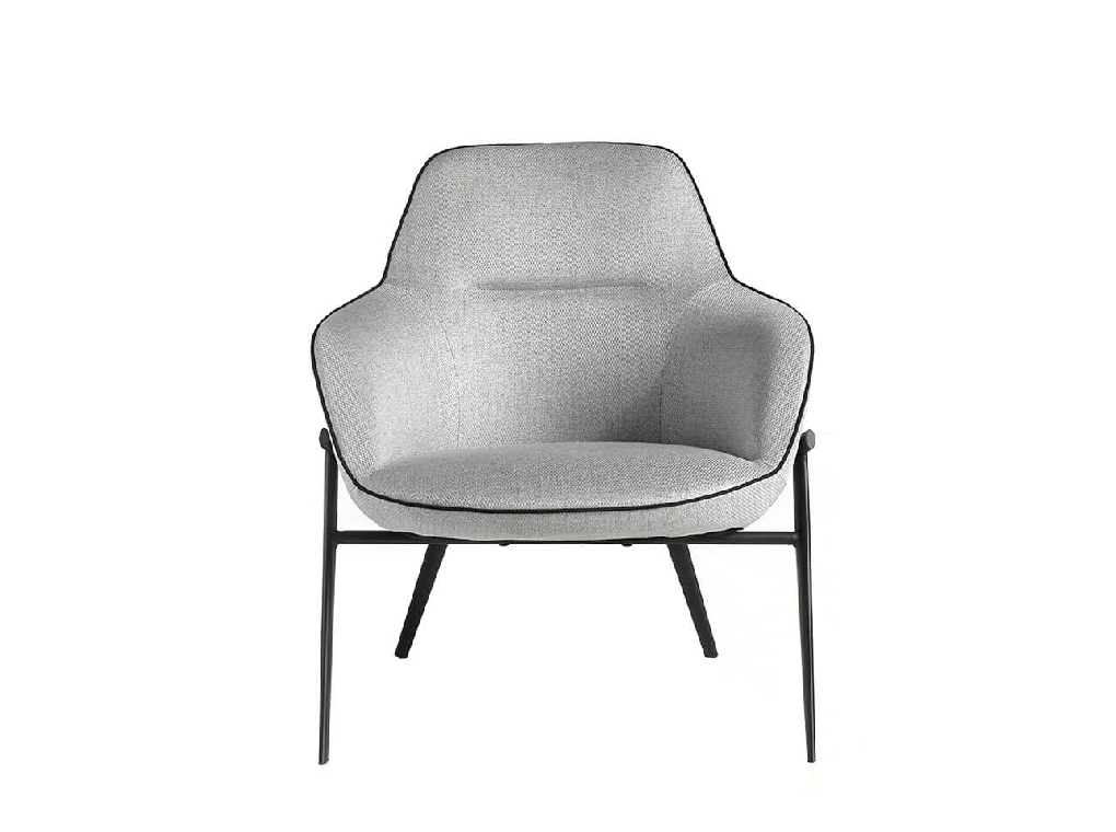 Confident armchair upholstered in fabric with piping