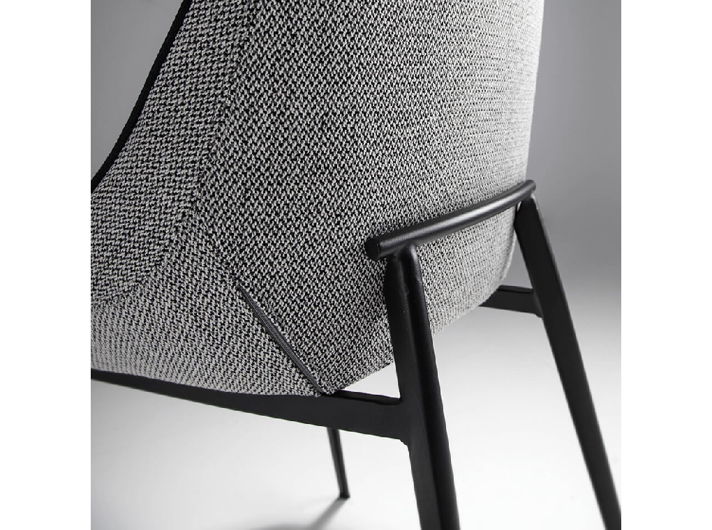 Chair upholstered in fabric with piping and black steel frame