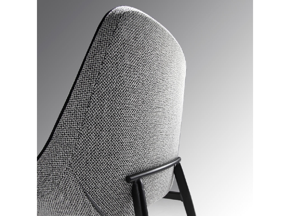Chair upholstered in fabric with piping and black steel frame